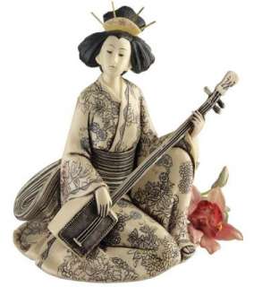 elegantly fingering her shamisen or three stringed lute this elegant 