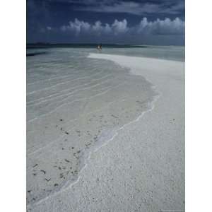  A Couple Strolling Along a White Sand Beach Under Gentle 