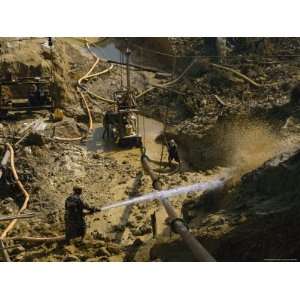 Gold Miners Blast Muddy Holes in the Earth with Water Premium 