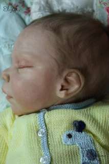 Elijah has hand rooted, wispy baby eyelashes in light brown to match 