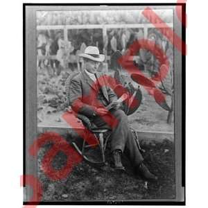 Luther Burbank reading outdoors with cactus Photograph
